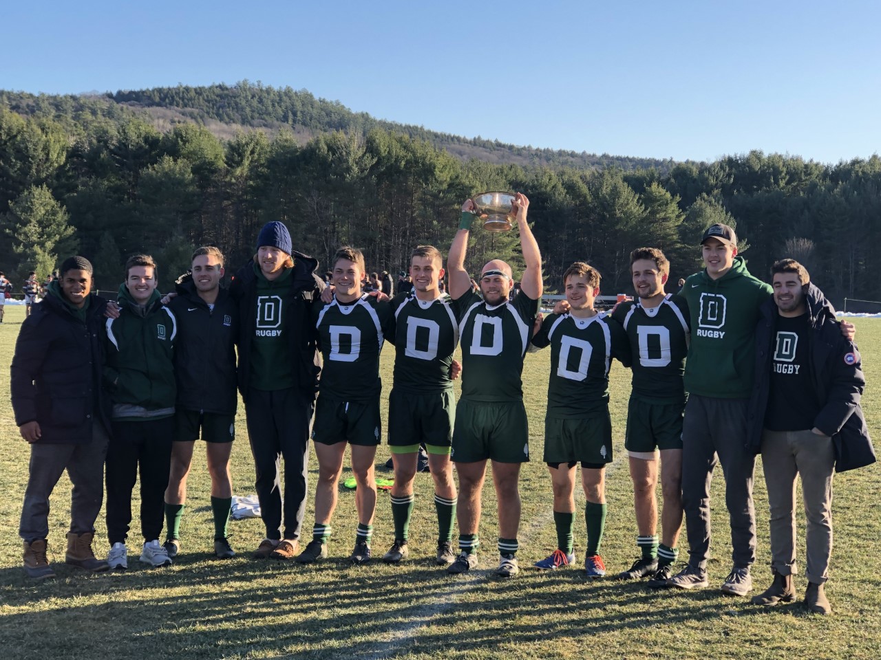 Dartmouth Men posing for a team photo with their trophy
