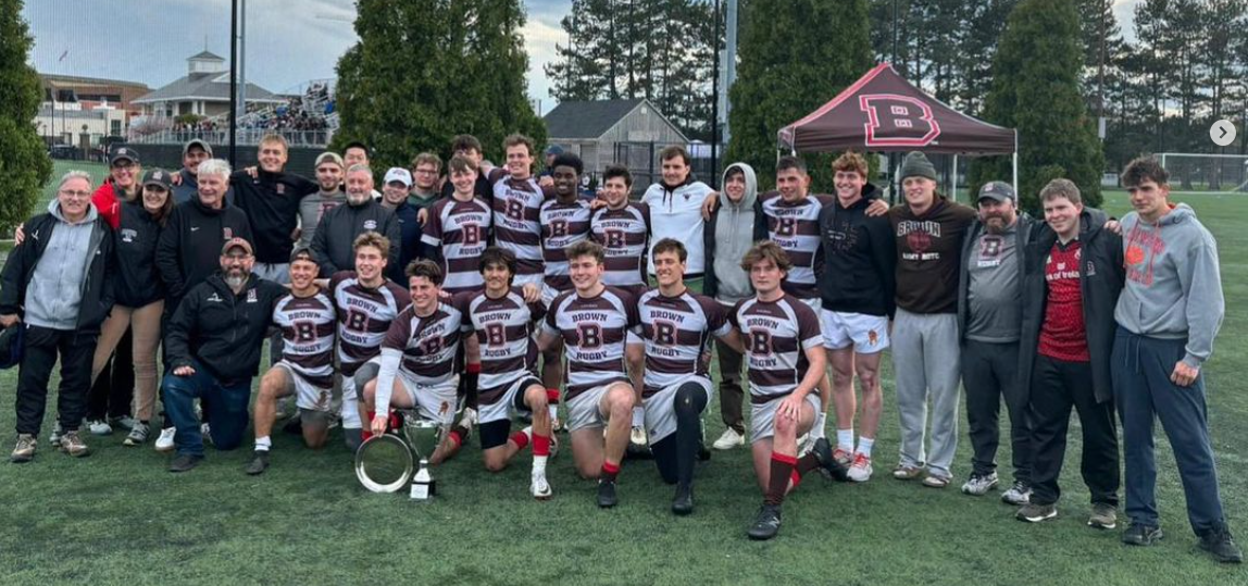 team surrounds Jay Fluck after 7s victory