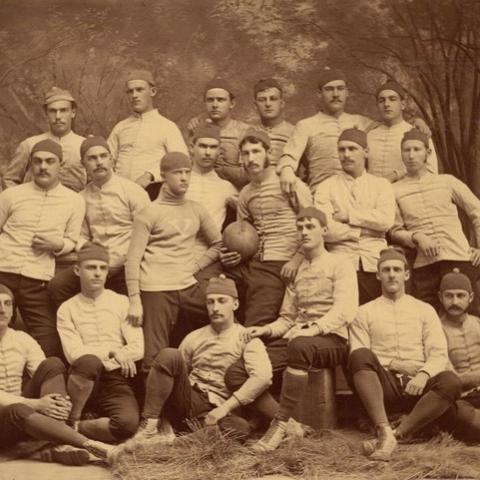 The 1879 Yale rugby team, with team captain Walter Camp (center, holding football).