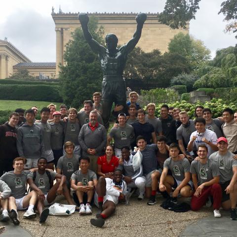 Brown Rugby in front of the rocky statue in Philly