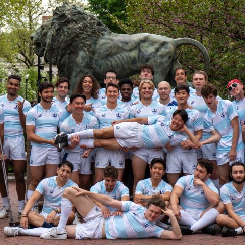 team in front of the Columbia lion