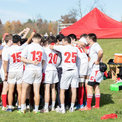 team gathers near tent before match