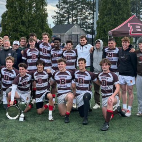 team surrounds Jay Fluck after 7s victory