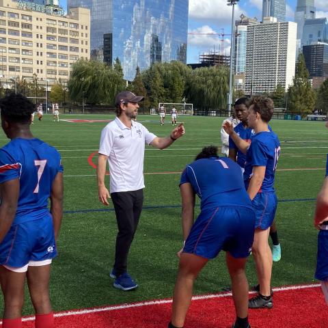 Penn coach with team in end zone