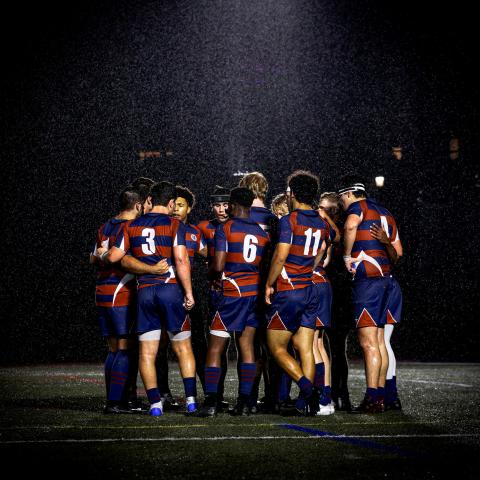 team huddle at night in rain