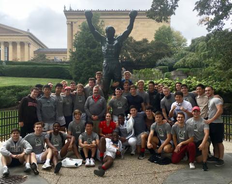 Brown Rugby in front of the rocky statue in Philly