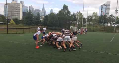Rugby scrum Brown v Penn with the Philly skyline in the background