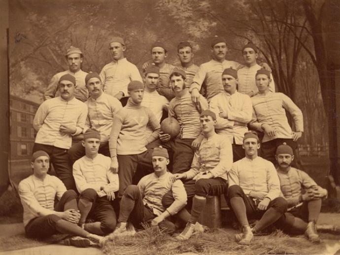 The 1879 Yale rugby team, with team captain Walter Camp (center, holding football).
