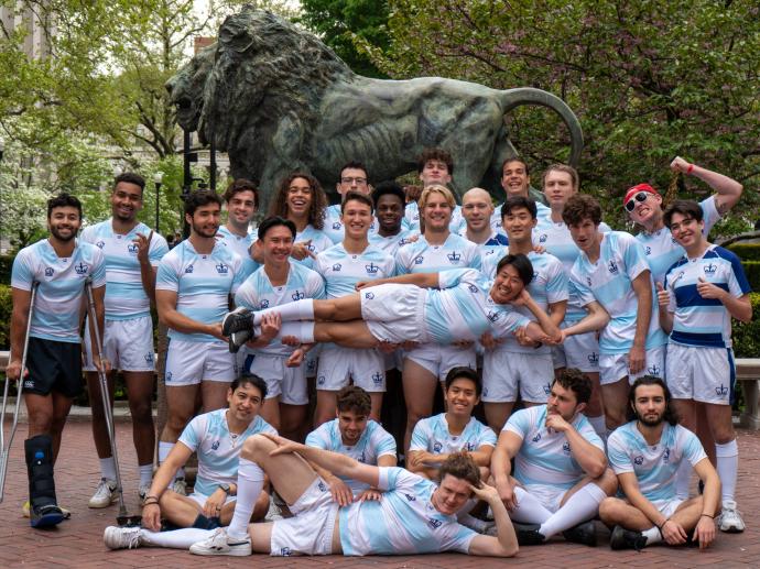 team in front of the Columbia lion