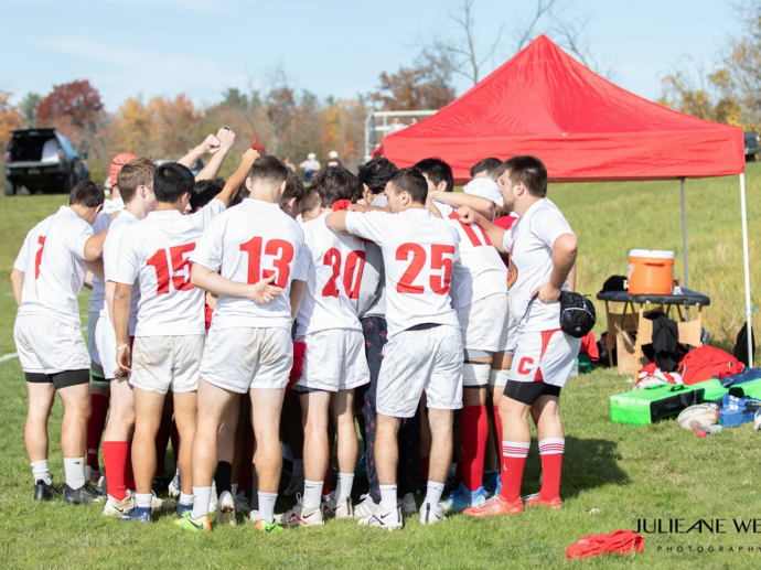 team gathers near tent before match